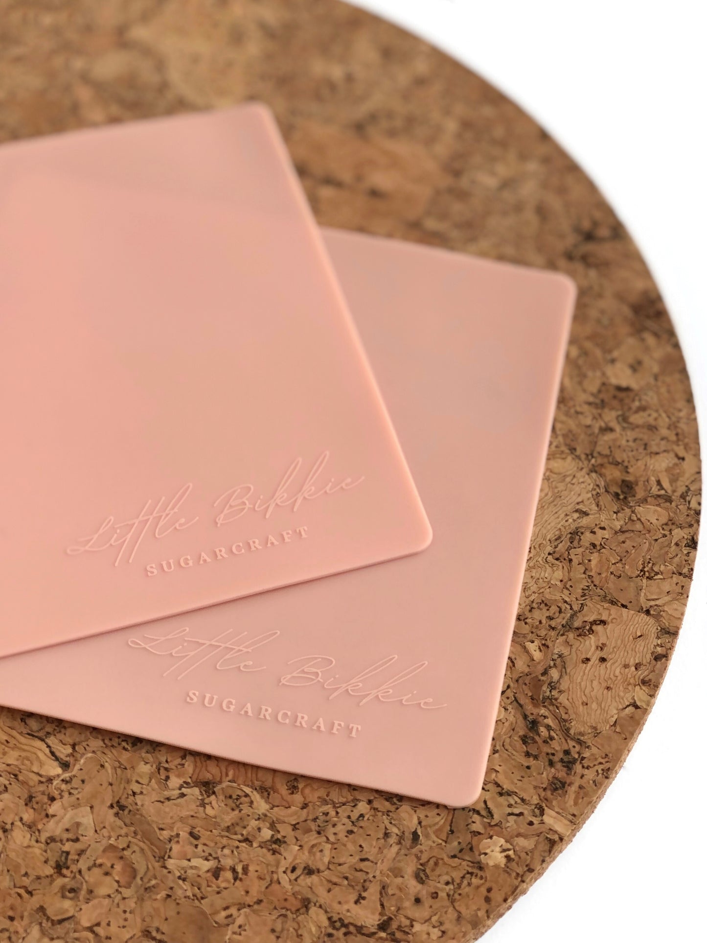 Small, pink silicone mat for use with cookie turntable.