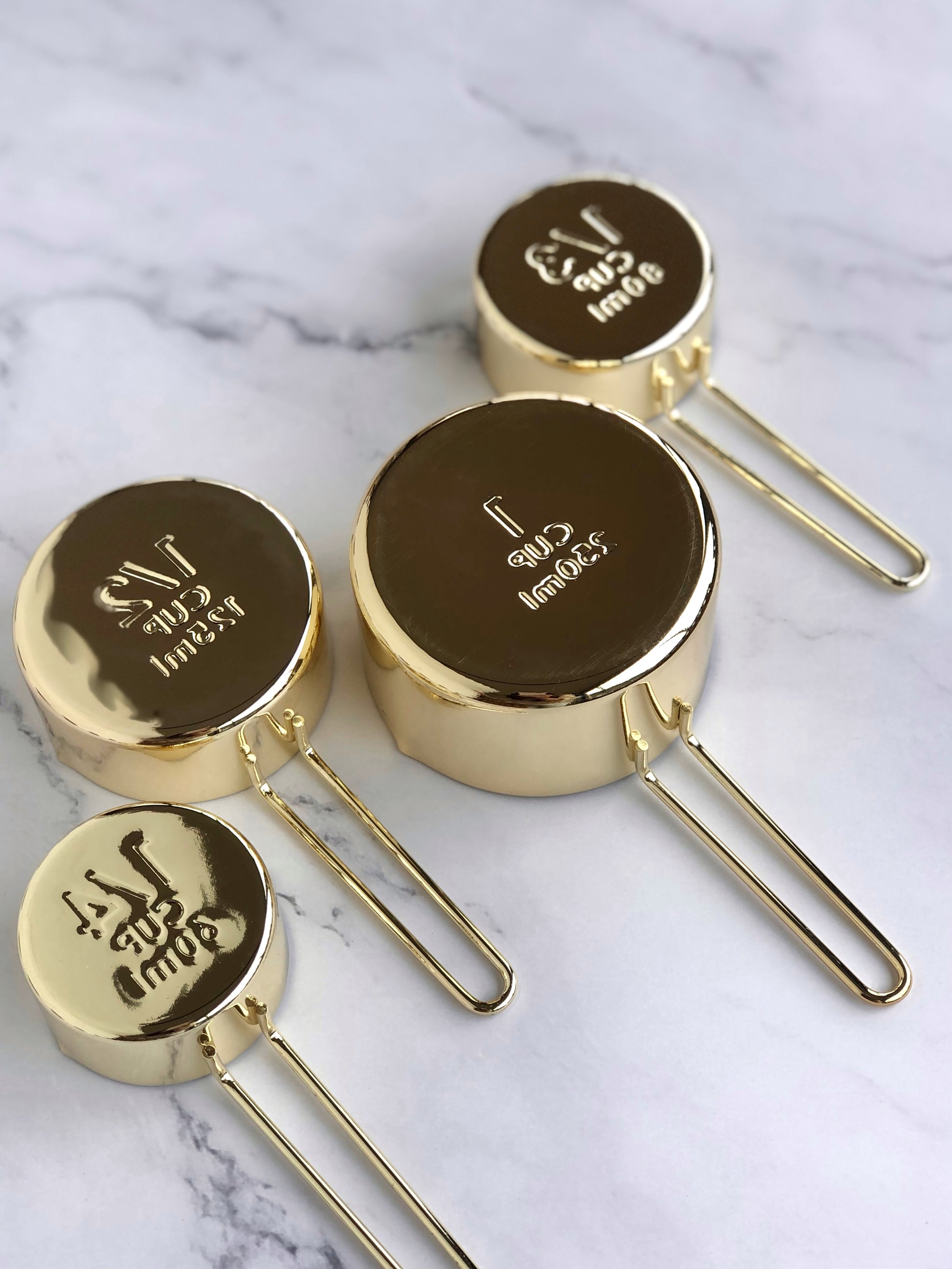 Gold measuring cups. Bottom view